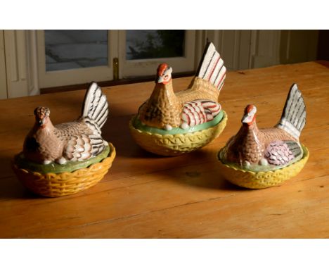 Three similar Staffordshire hen tureens and ozier-moulded bases, late 19th or early 20th century, typically modelled as brood
