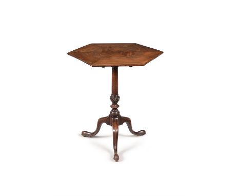 A George III mahogany tripod table, circa 1770, in the manner of Thomas Chippendale, the hinged hexagonal top, above the turn