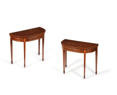 A pair of George III mahogany and satinwood folding card tables, circa 1790, each hinged demi-lune top opening to baize inset