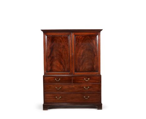 A George III mahogany clothes press, circa 1780, in the manner of Thomas Chippendale, the moulded cornice above a pair of pan