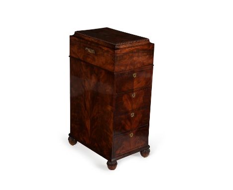 A George IV mahogany Davenport, circa 1825, by William Wilkinson, the hinged rectangular cavetto moulded top revolving and op