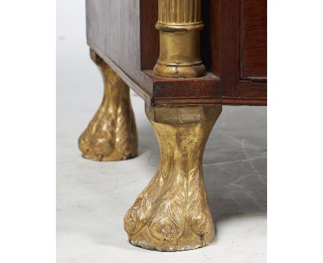 A George III patridgewood and parcel gilt bowfront commode, circa 1805, the shaped top with line inlaid edge, above three lon