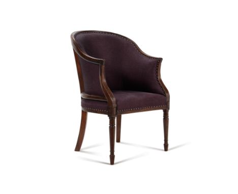 A George III mahogany and upholstered armchair, circa 1810, often associated with being a desk chair, the shaped back and arm