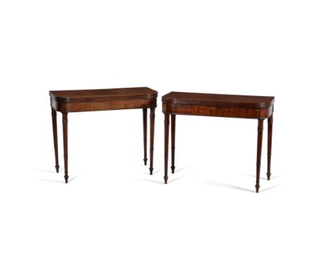 A pair of Regency 'plum pudding' mahogany tea tables, circa 1815, each hinged D-shaped top with reeded edge, above a plain fr
