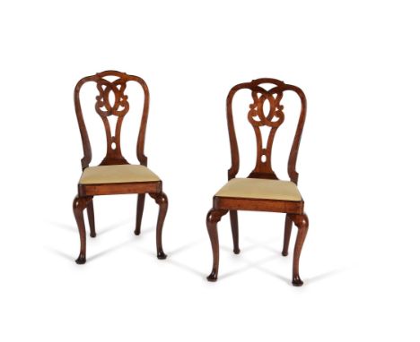 A pair of George II walnut side chairs, circa 1750, the shaped backs centred by a pierced and scrolling vase shaped splat, ab