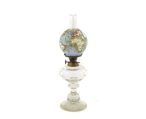 An Austrian Glass Oil Lamp, early 20th century, the opaque white glass shade printed and overpainted with the globe, on metal