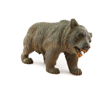 A Black Forest Type Carved Wooden Figure of a Bear, early 20th century, naturalistically carved standing four-square, with gl