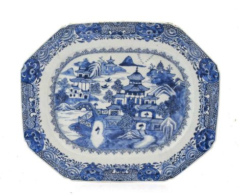 A Chinese Porcelain Platter, Qianlong, of canted rectangular form, painted in underglaze blue with figures and pagodas in a r