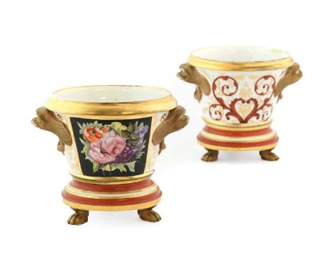 A Pair of English Porcelain Cache Pots and Stands, probably Spode, circa 1820, of bucket form with mask handles, painted with