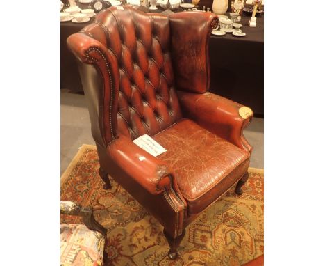 Oxblood leather Chesterfield wingback armchair with button back footstool and three seat matching settee, A/F CONDITION REPOR