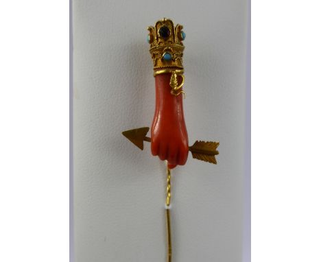 An Antique 20/22 Ct Gold, Coral, Turquoise and Garnet Stick Pin, the coral carved in the form of a hand holding Cupid's arrow