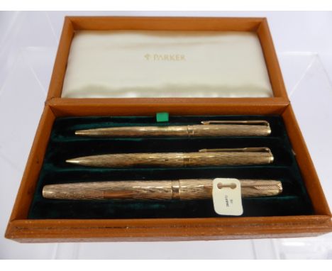 A 9 Ct Gold Vintage Flamme Parker Pen Set, comprising ink pen, biro pen and pencil in the original box.