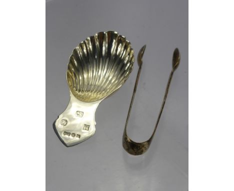 A Silver Caddy Spoon, Birmingham hallmark dd 1982, mm A.M. & Co., together with a pair of sugar nips Sheffield hallmark dd 19
