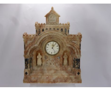 A Hand Carved Marble Clock Carved in the Form of a Church Building, having two hand carved religious figures on each side, th