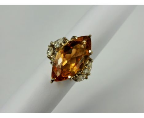 A Lady's 10.34 Ct Imperial Topaz 18 Ct White Gold and Diamond Ring, the exquisite peach coloured marquise natural topaz measu