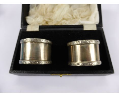 A Pair of Silver Napkin Rings, Birmingham hallmark, mm W.H. Manton Ltd., dd 1967 in the original box together with six silver