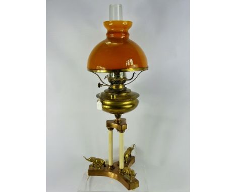 An Antique 'Lampe Veritas' Brass Oil Lamp, raised on a classical column form base depicting brass elephants to base, amber sh