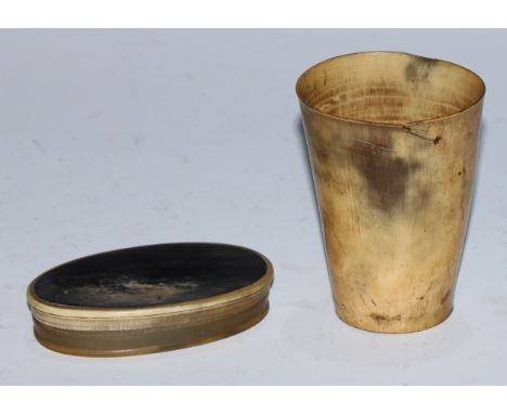 A 19th century cattle horn oval snuff box, probably Scottish, 9.5cm wide, c.1850; a beaker, similar, 9cm high (2) 