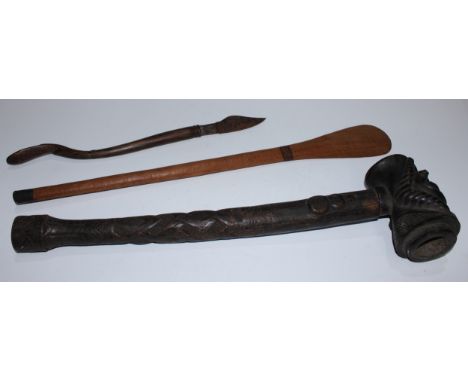 Tribal Art - a large Kuba pipe, the bowl carved with a mask of highly stylised features, the stem in relief with an animal an