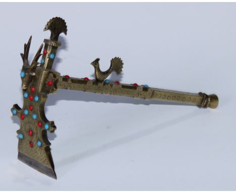 A Tibetan brass ceremonial adze, steel blade, deer and peacock crestings, applied with coral and turquoise cabochons, 26cm lo