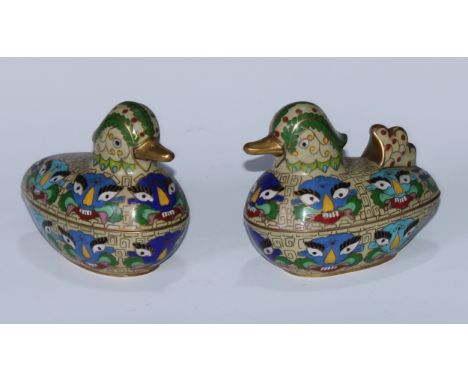 A pair of Chinese cloisonne enamel boxes and covers, as ducks, decorated in polychrome with toatie masks, scrolls, leaves and