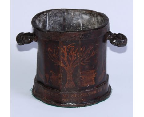 A George III japanned lead tobacco jar, decorated in gilt with a tree, a pipe, ale glass, jug and pipe, initialled J W and in