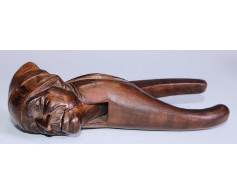 Nutcrackers - a Black Forest novelty lever-action nut cracker, carved as a man wearing a headscarf, 17.5cm long, c.1900 