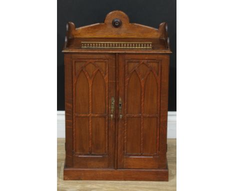 A Gothic Revival oak and mahogany table-top collector's cabinet, shaped three-quarter gallery centred by a draught-turned rou