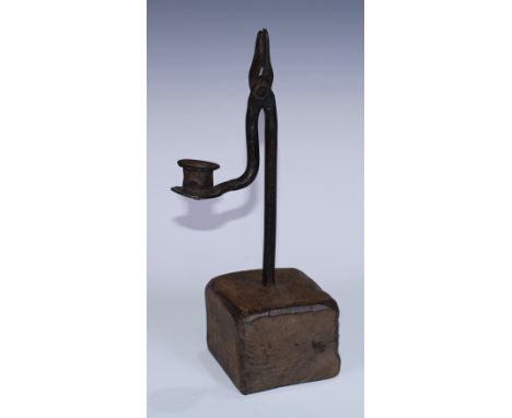 A wrought iron nip rush light holder and candle sconce, square oak base, 30.5cm high 