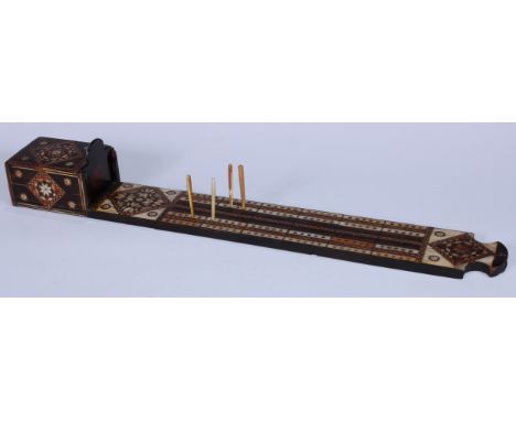A Middle-Eastern hardwood and bone marquetry gaming board, in the Moorish taste, inlaid for cribbage in specimen timbers and 