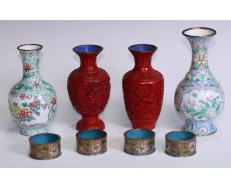 A pair of Chinese cinnabar lacquer ovoid vases, carved in relief with chrysanthemums and scrolls, pale blue counter enamel, 1