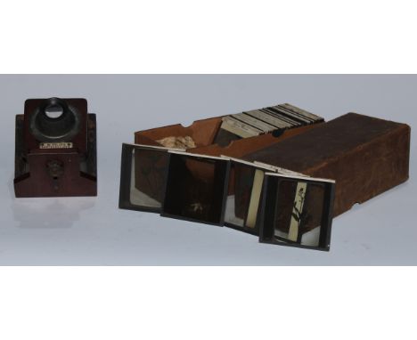 A Victorian monocular slide viewer, W. Tylar's Lanternescope, 57, High Street, Aston, Birmingham, 25cm long; a collection of 