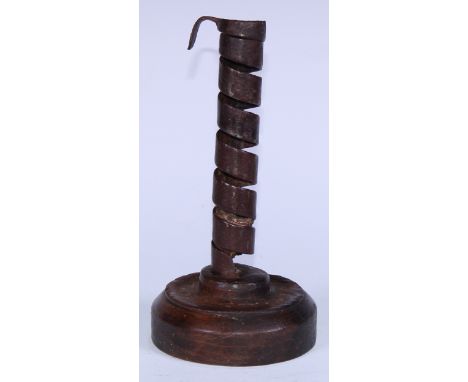 A 19th century wrought iron spiral candlestick, softwood base, 20cm high 