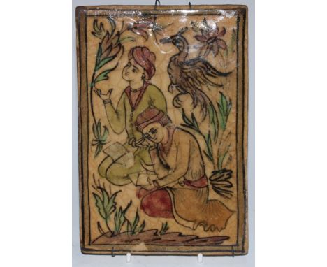 A Persian rectangular tile, painted in the typical Qajar manner with figures learning and reciting texts, 19.5cm x 13.5cm 