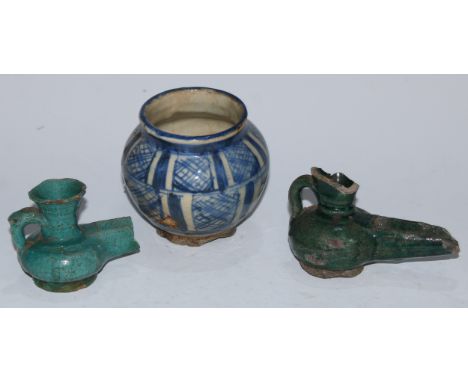 A Persian earthenware globular vessel, painted in the Islamic taste in tones of blue on a white ground, 10cm high, 17th centu