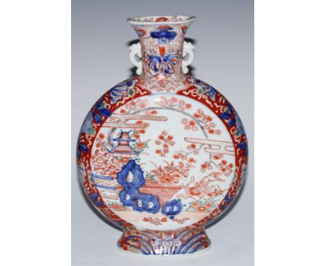 A Japanese porcelain moon flask, of Chinese influence, painted in the Imari palette with pagodas, landscapes and flowers, 27.