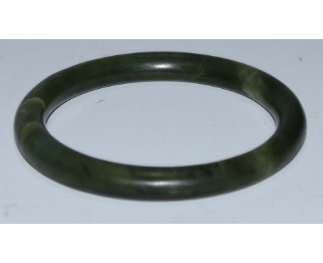 A jade bangle, 8cm diam 