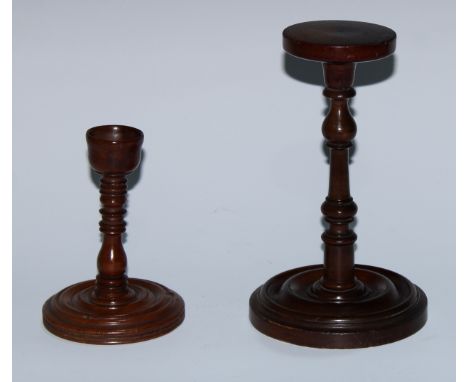 Treen - a 19th century turned fruitwood candlestick, 13cm high; a turned candle stand, 20cm high (2) 
