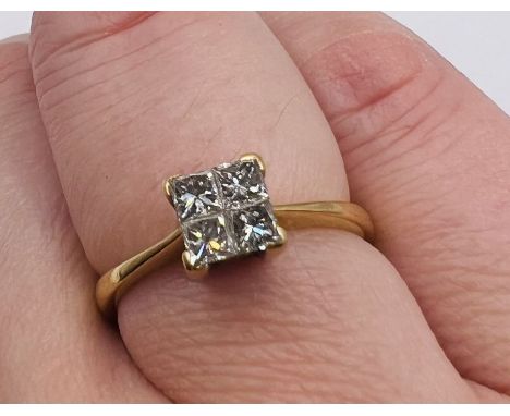 A square set diamond and 18ct gold ring. Featuring four princess cut diamonds in an illusion setting with an estimated 0.50 c
