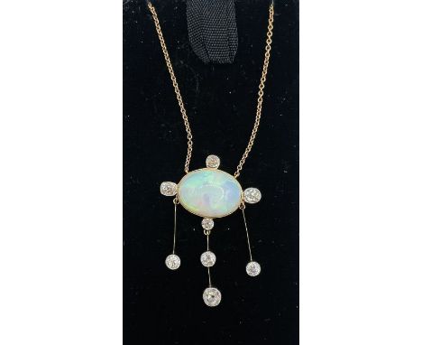 An Edwardian opal and diamond negligee necklace featuring a scattering of old mine cut diamonds of varying sizes ranging from