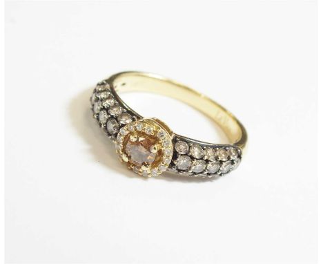 A Le Vian champagne coloured diamond ring, the brilliant cut champagne diamond claw set within a graduated border of fifteen 