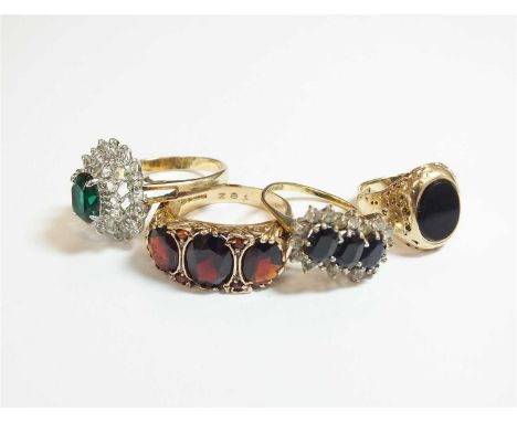 A 9ct gold sapphire ring cluster ring, size M, together with a 9ct gold garnet ring, size O, a 9ct gold onyx set signet ring,