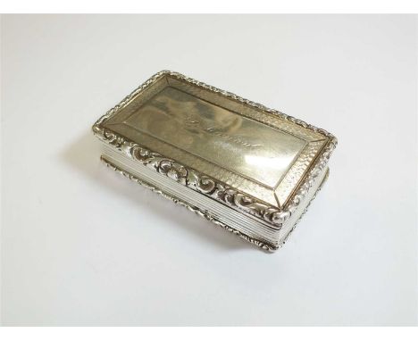 A William IV silver snuff box, Francis Clark, Birmingham 1833, of rectangular from with floral scroll cast rim, the cover eng