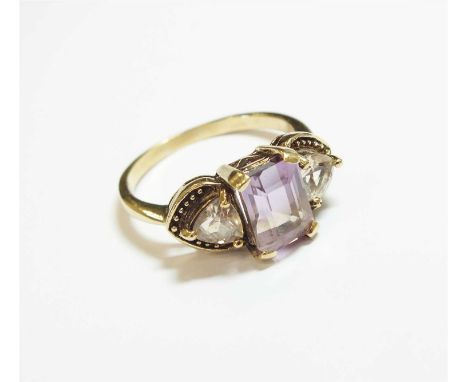 A 9ct gold ametrine ring, designed as a central rectangular faceted ametrine claw set in yellow gold and flanked to each side