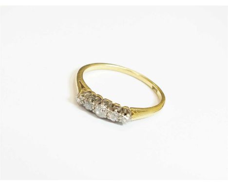 A graduated five stone diamond ring, the old cut diamonds claw set in white metal to yellow metal shank, stamped '18ct', ring