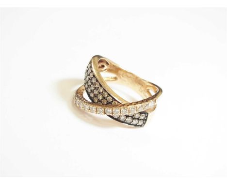 A Le Vian diamond crossover ring, designed as a tapering two-three row of of pave set brilliant cut diamonds mounted with a c