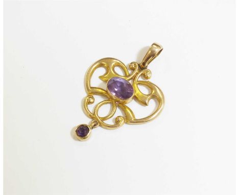 A 9ct gold Edwardian amethyst pendant, designed as a central oval mixed cut amethyst collet set in yellow gold to openwork sc