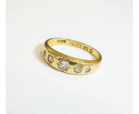 A Victorian 18ct gold five stone diamond ring, designed as five graduated old cut diamonds gypsy set to yellow gold tapering 