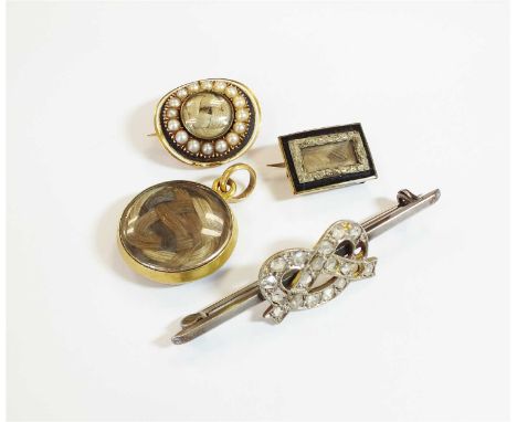 An early 19th century enamel and split pearl mourning brooch, the centre aperture enclosing plaited ring of hair, within spli