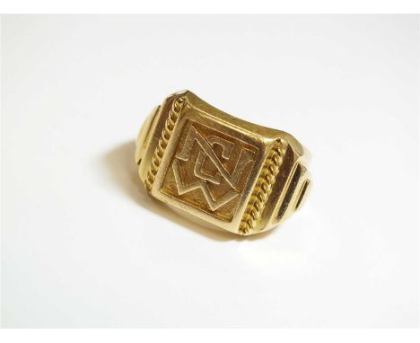 A yellow metal signet ring, the square plaque with carved initials 'N C W', set to stepped geometric shoulders, the shank sta